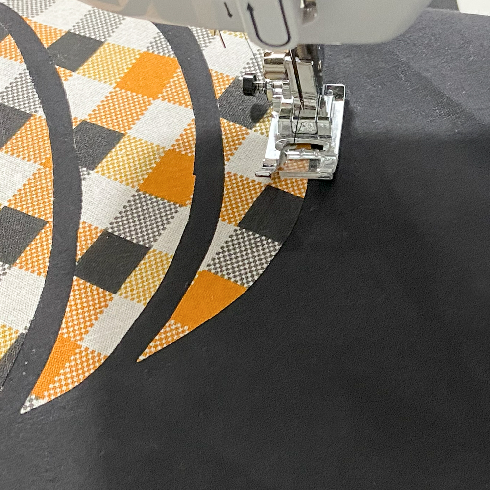 Stitch applique with a zig zag or blanket stitch around each piece