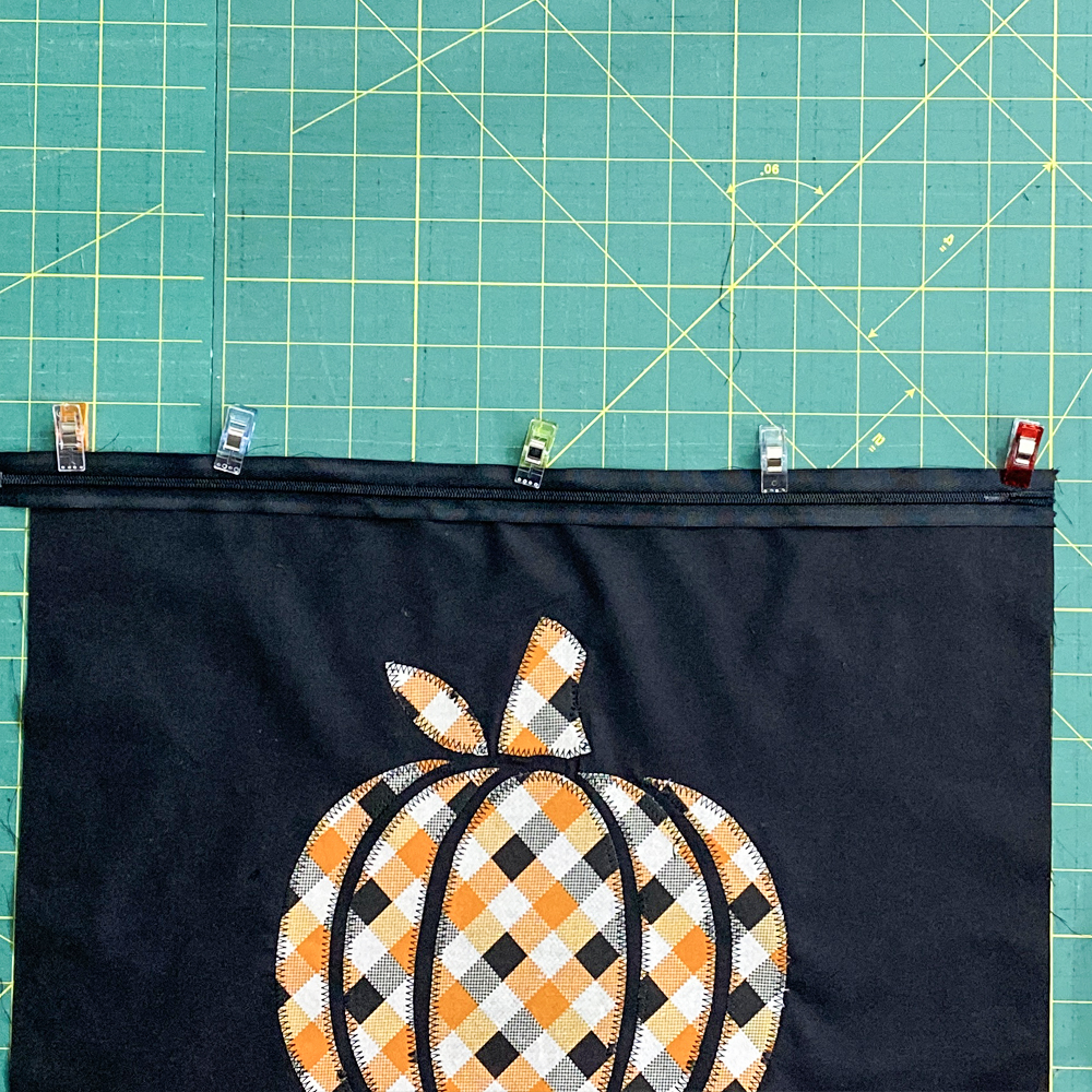 Pin one side of zipper into place